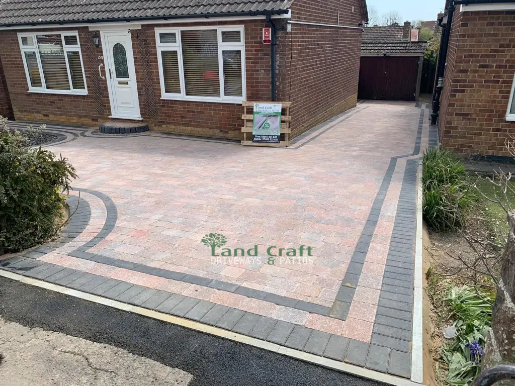 Buff block paved driveway with a grey double border