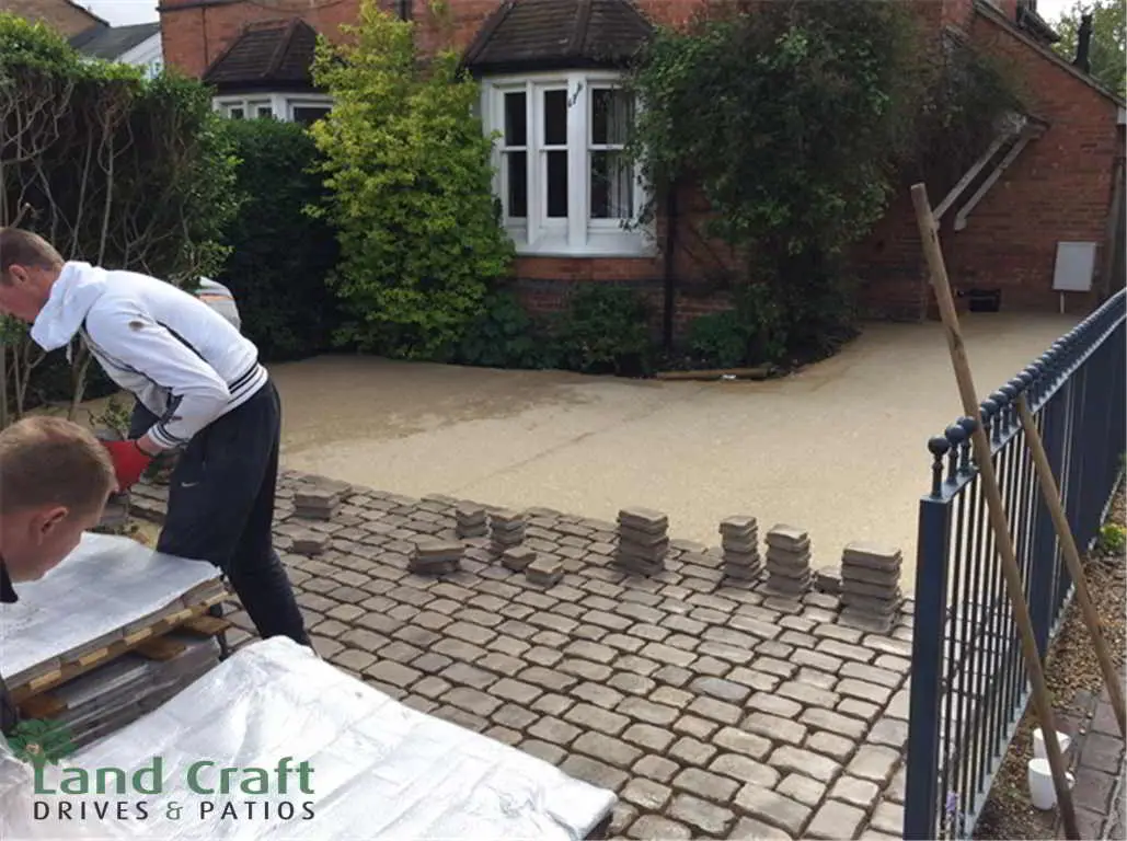 Cobble block paving being laid by hand