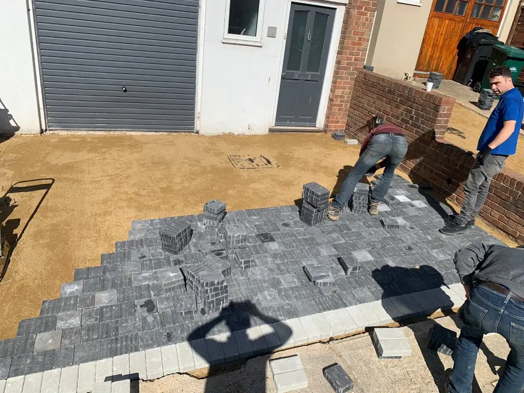 Block paving being relaid by hand on a prepared base