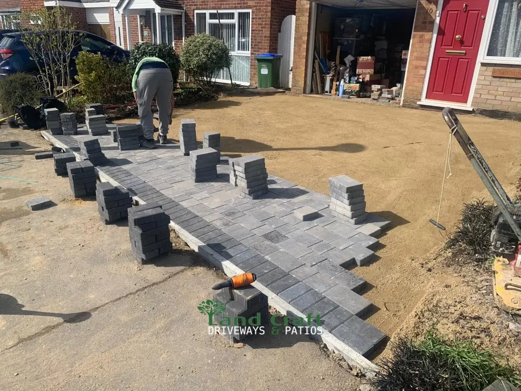 Block paving being laid across a front garden