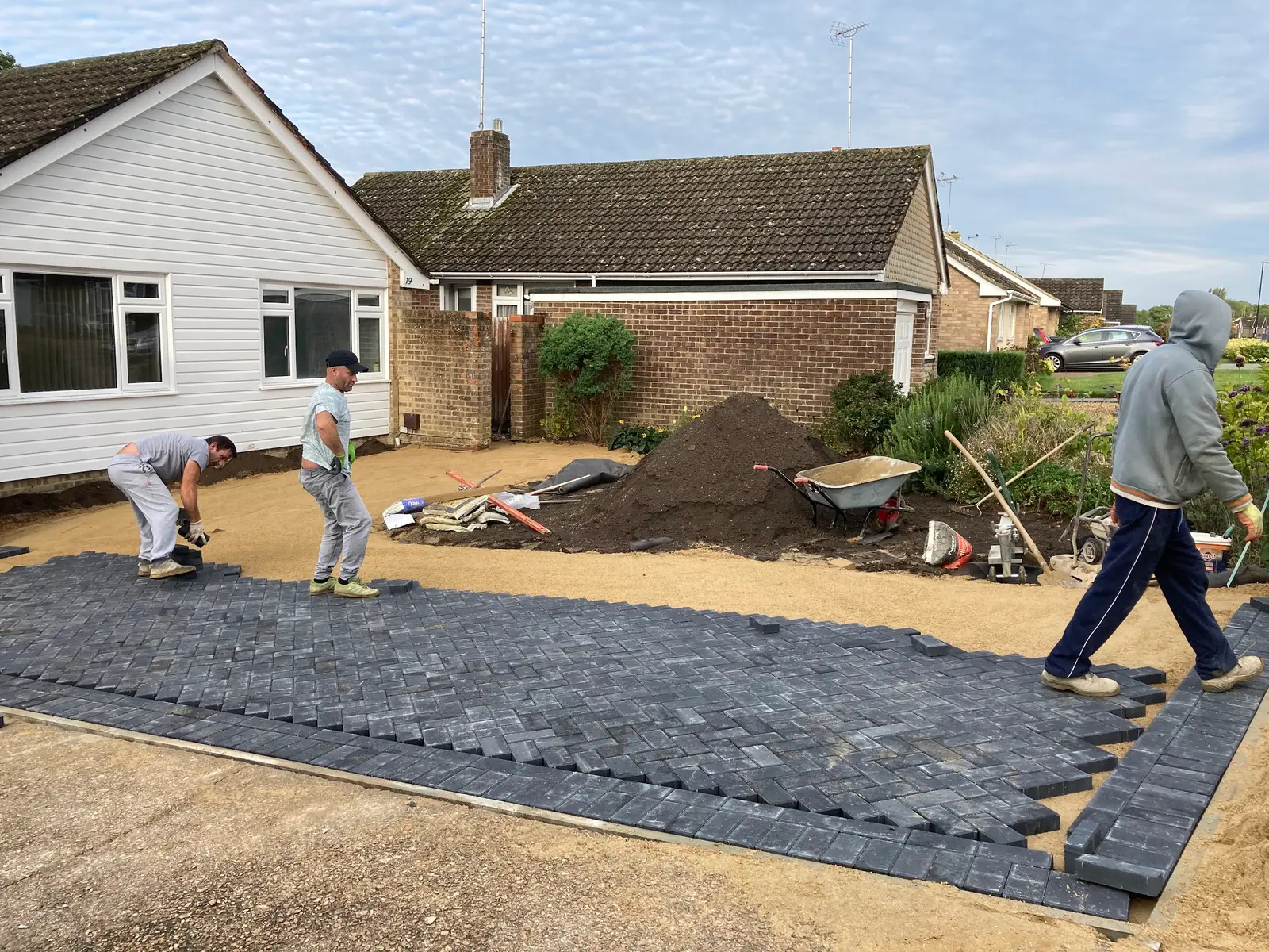Block edging being set for a new driveway
