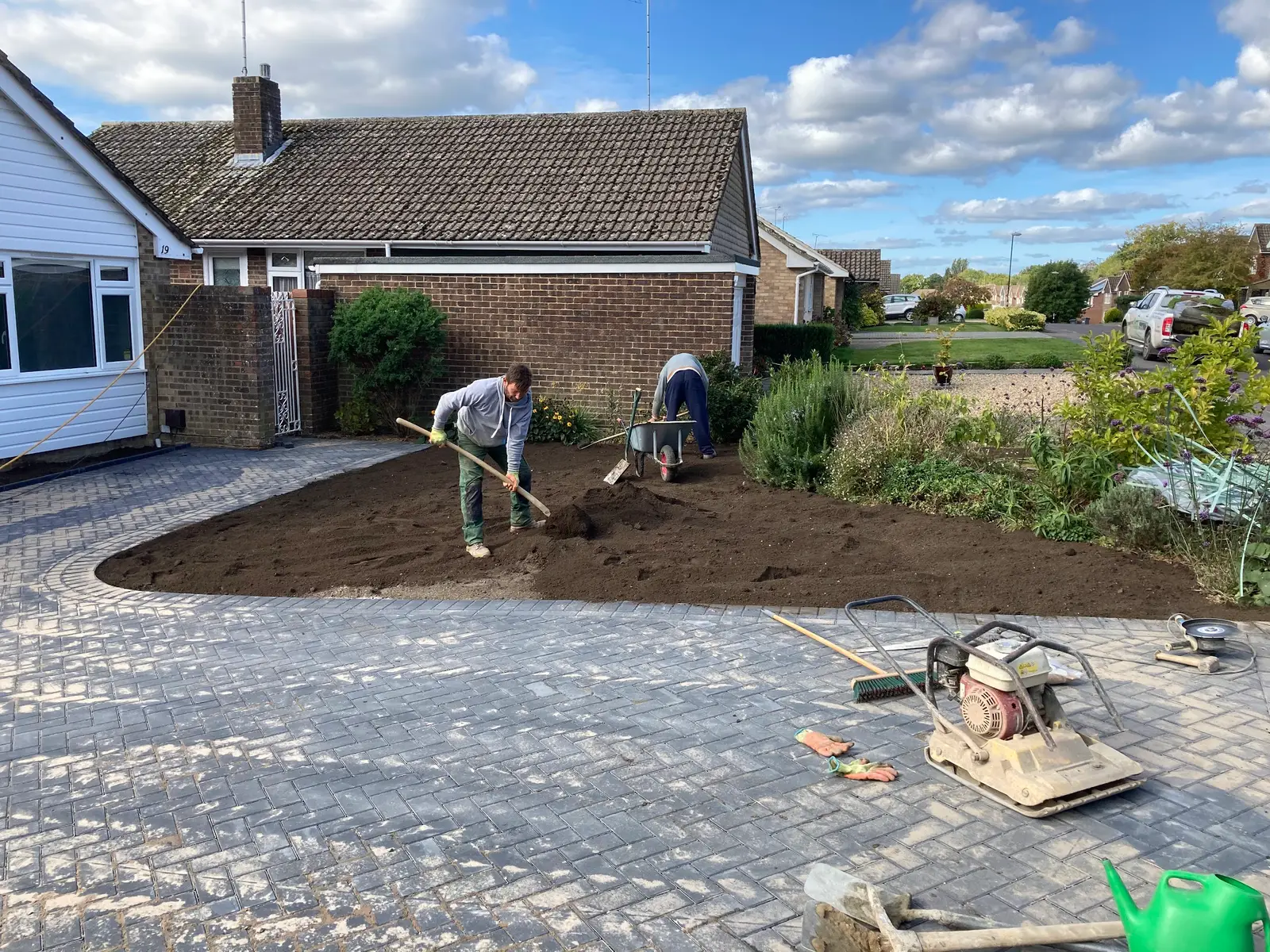 Final soil and levelling beside a new driveway