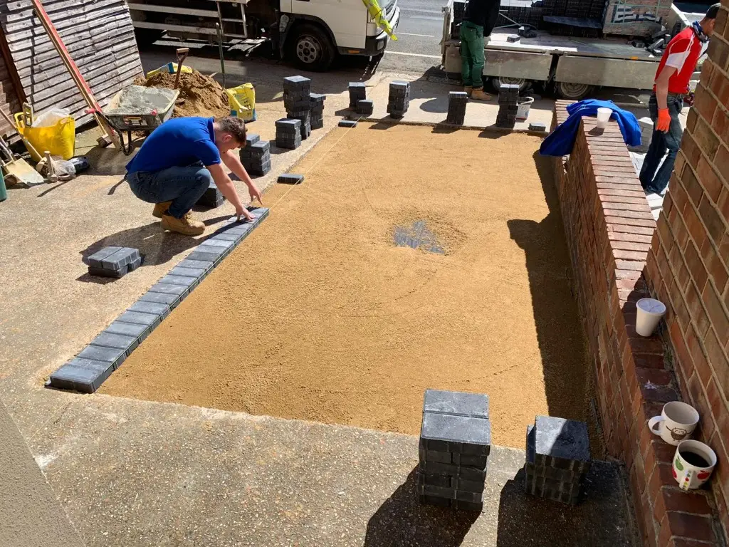 Block edging being laid on a sand base