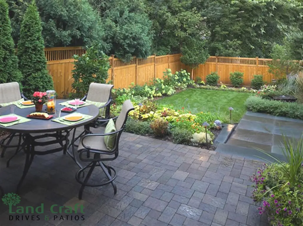 Dark porcelain patio with a dining set and planting