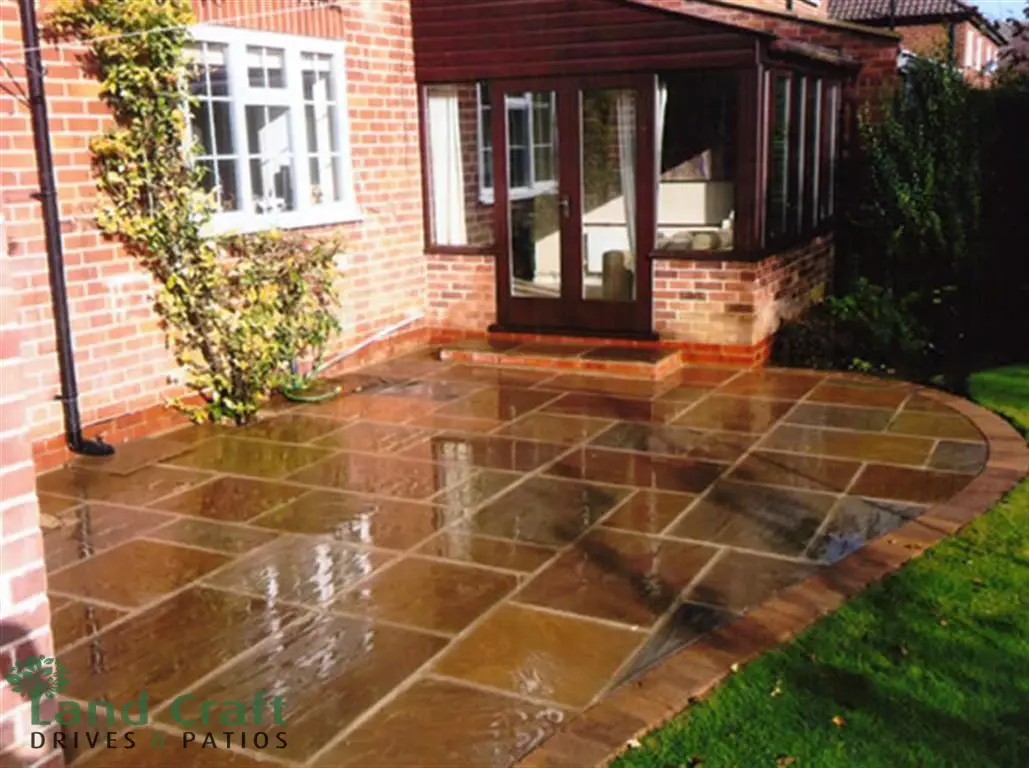 Sandstone patio outside French doors after rain
